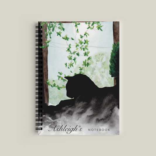 Notebook with a bear silhouette and floral design on the cover, featuring the name 'Ashleigh'.