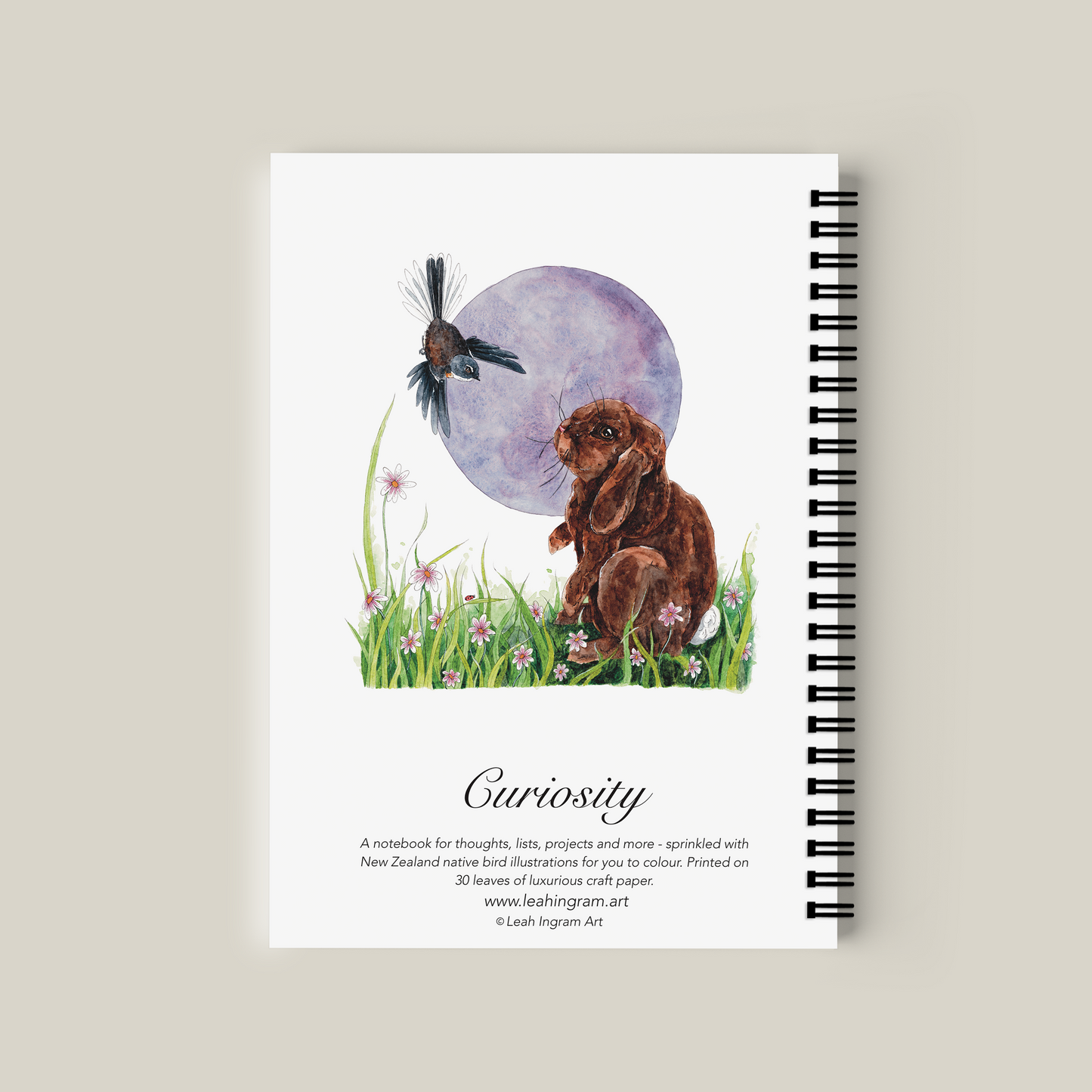 Notebook with a rabbit and butterfly illustration on a beige background