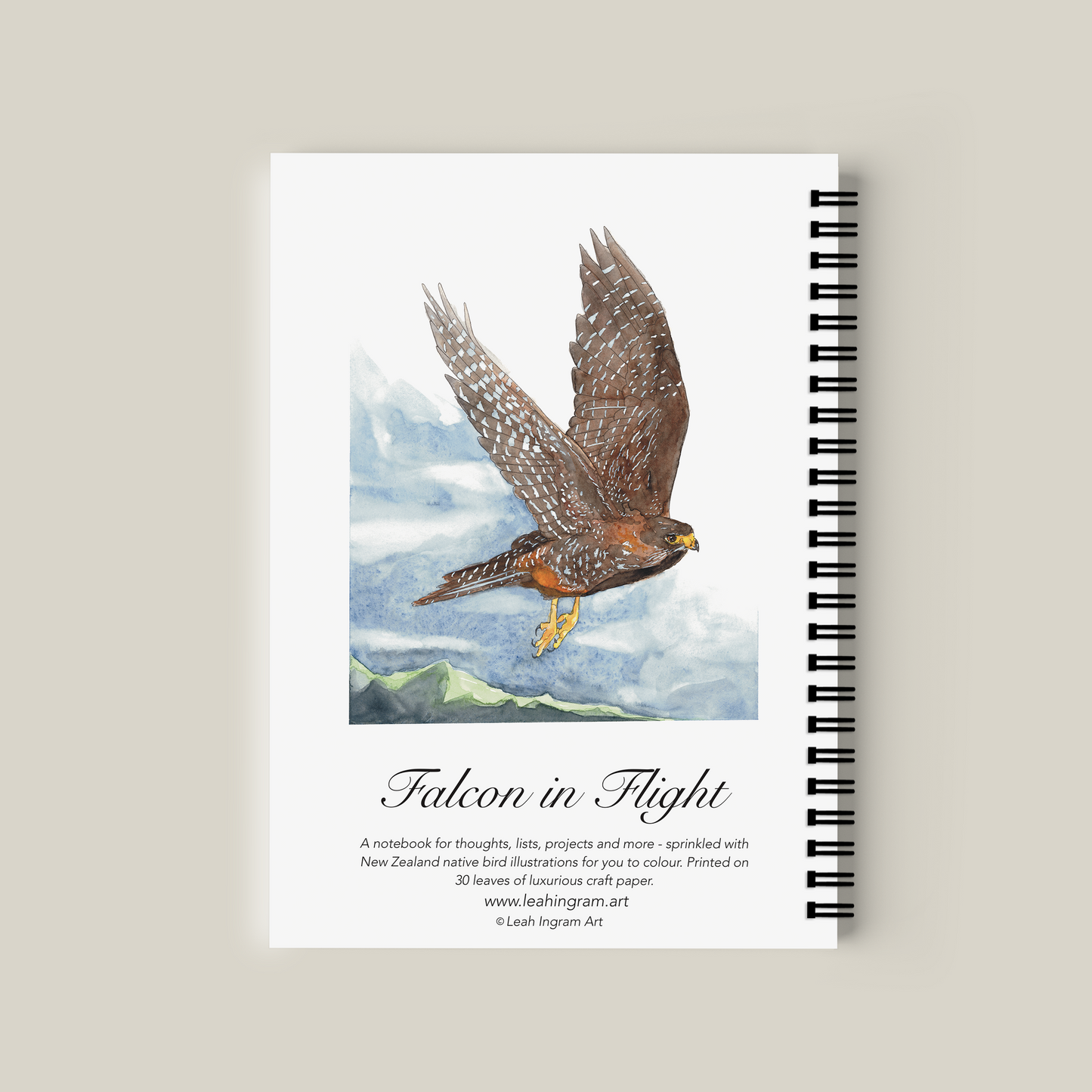Notebook with a falcon illustration on the cover against a beige background