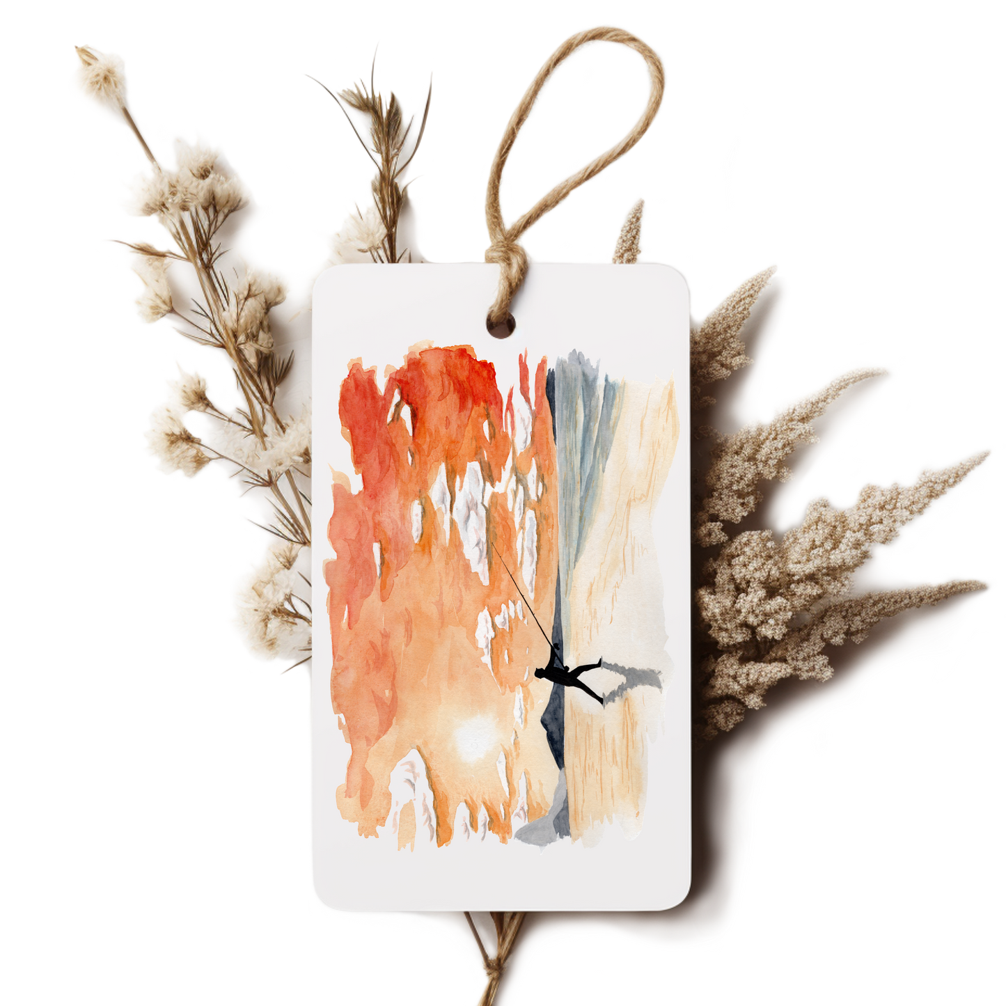 Decorative tag with abstract art and dried plants on a white background