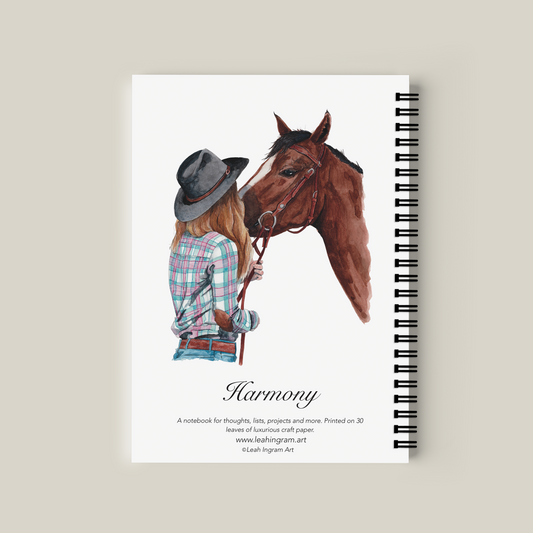 Notebook with illustration of a person and horse on the cover, titled 'Harmony'.