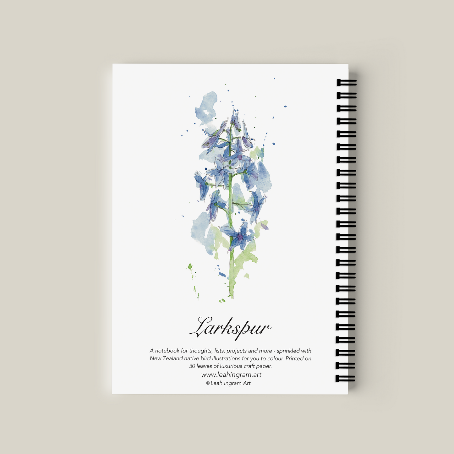 Notebook with floral design and text on a beige background