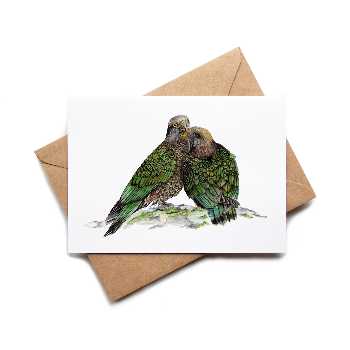 Card with illustration of two green parrots on a white background with a brown envelope.