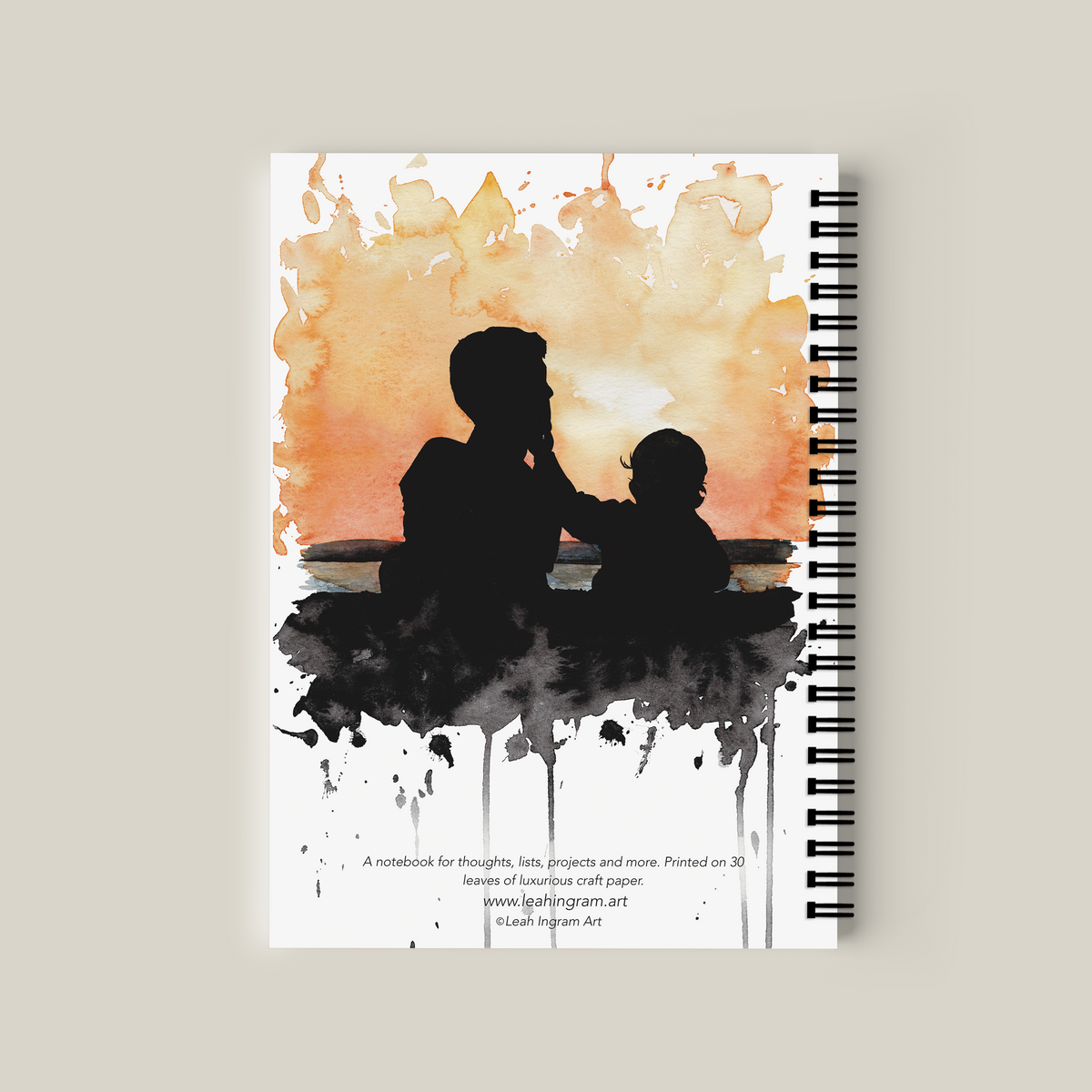 Notebook with a cover design of a silhouette of a child and adult against a watercolor background.