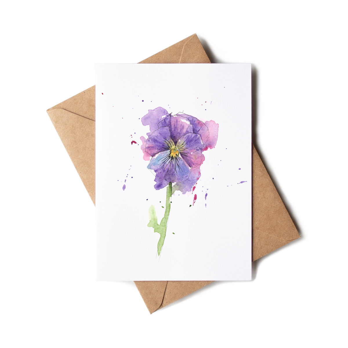 Greeting card with a purple flower illustration on a white background, accompanied by a brown envelope.