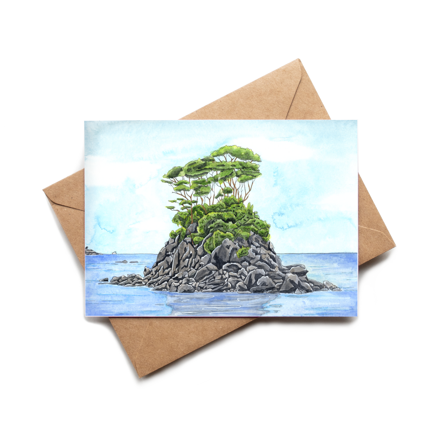 Greeting card with a painting of a small island with a tree on a brown envelope.