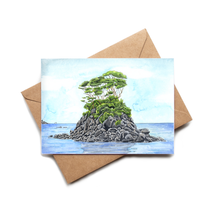 Greeting card with a painting of a small island with a tree on a brown envelope.