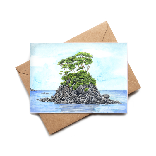 Greeting card with a painting of a small island with a tree on a brown envelope.