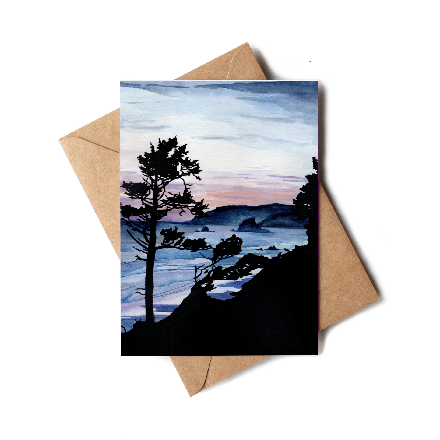Greeting card with a scenic landscape of trees and mountains, placed on a brown envelope.