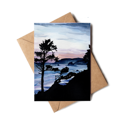 Greeting card with a scenic landscape of trees and mountains, placed on a brown envelope.