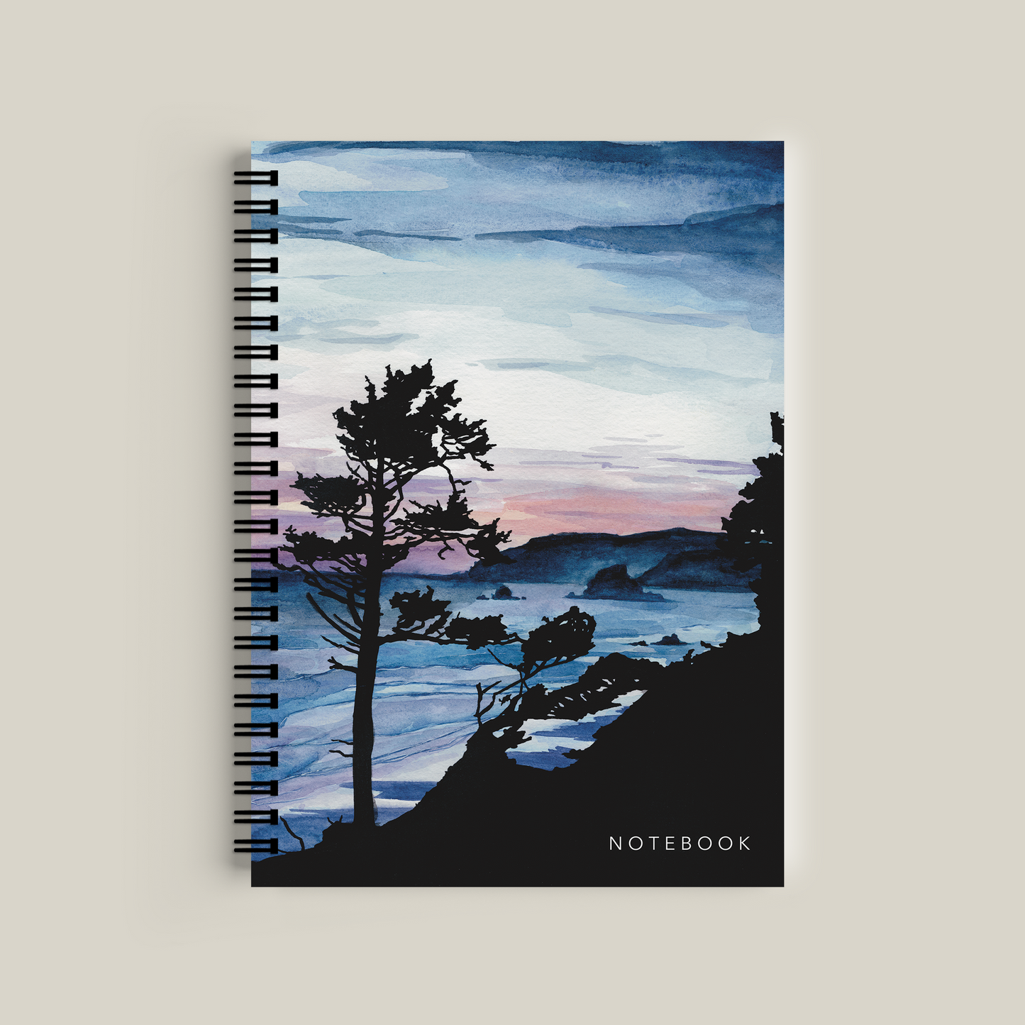 Notebook with a scenic cover featuring trees and water on a beige background
