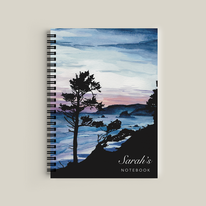 Notebook with a scenic cover featuring trees and water, labeled 'Sarah's Notebook'.