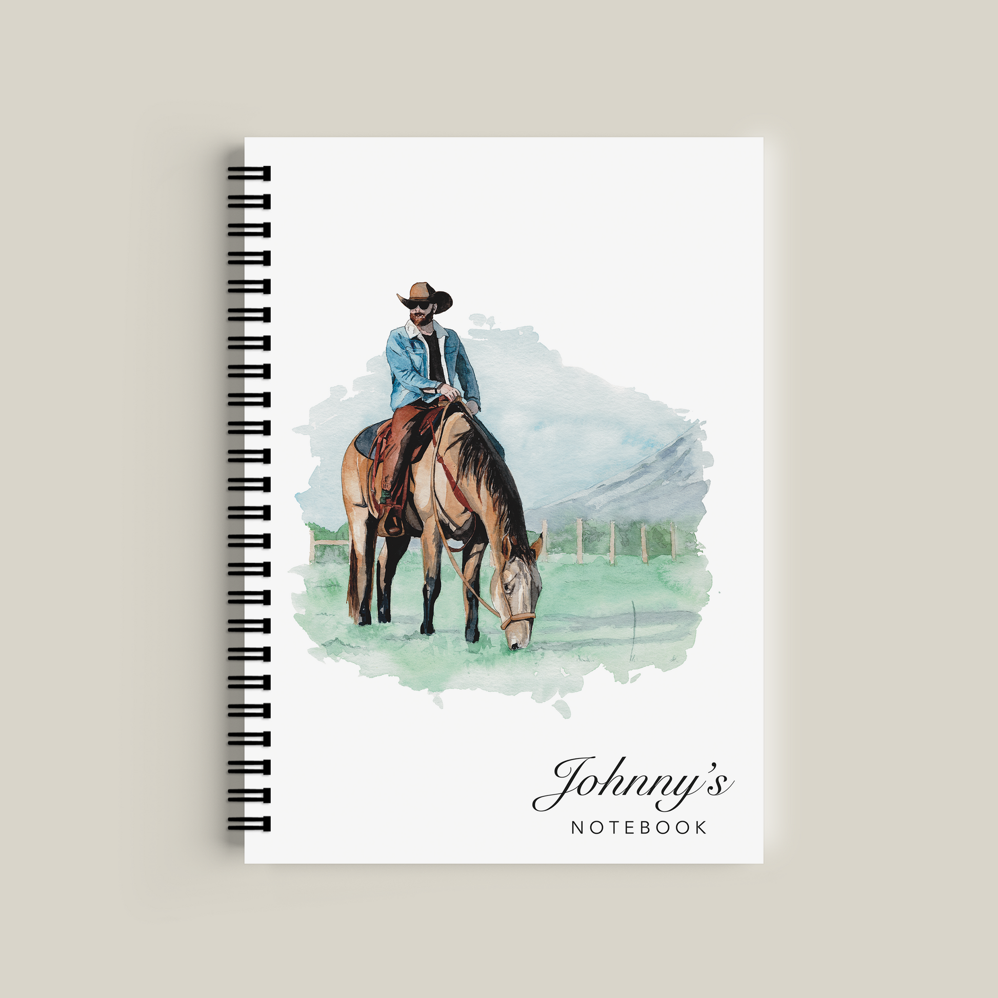 Notebook with a cover illustration of a person on a horse and the text 'Johnny's Notebook' on a beige background.