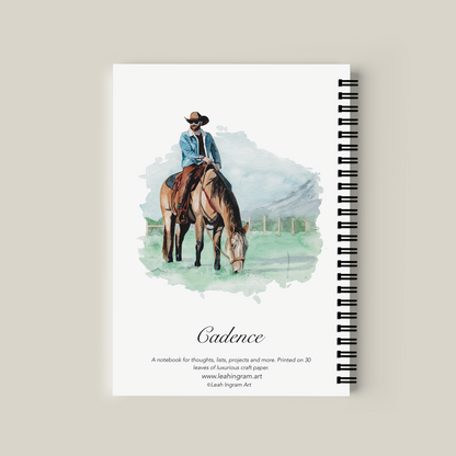 Notebook with a cover illustration of a person on a horse, titled 'Cadence'.