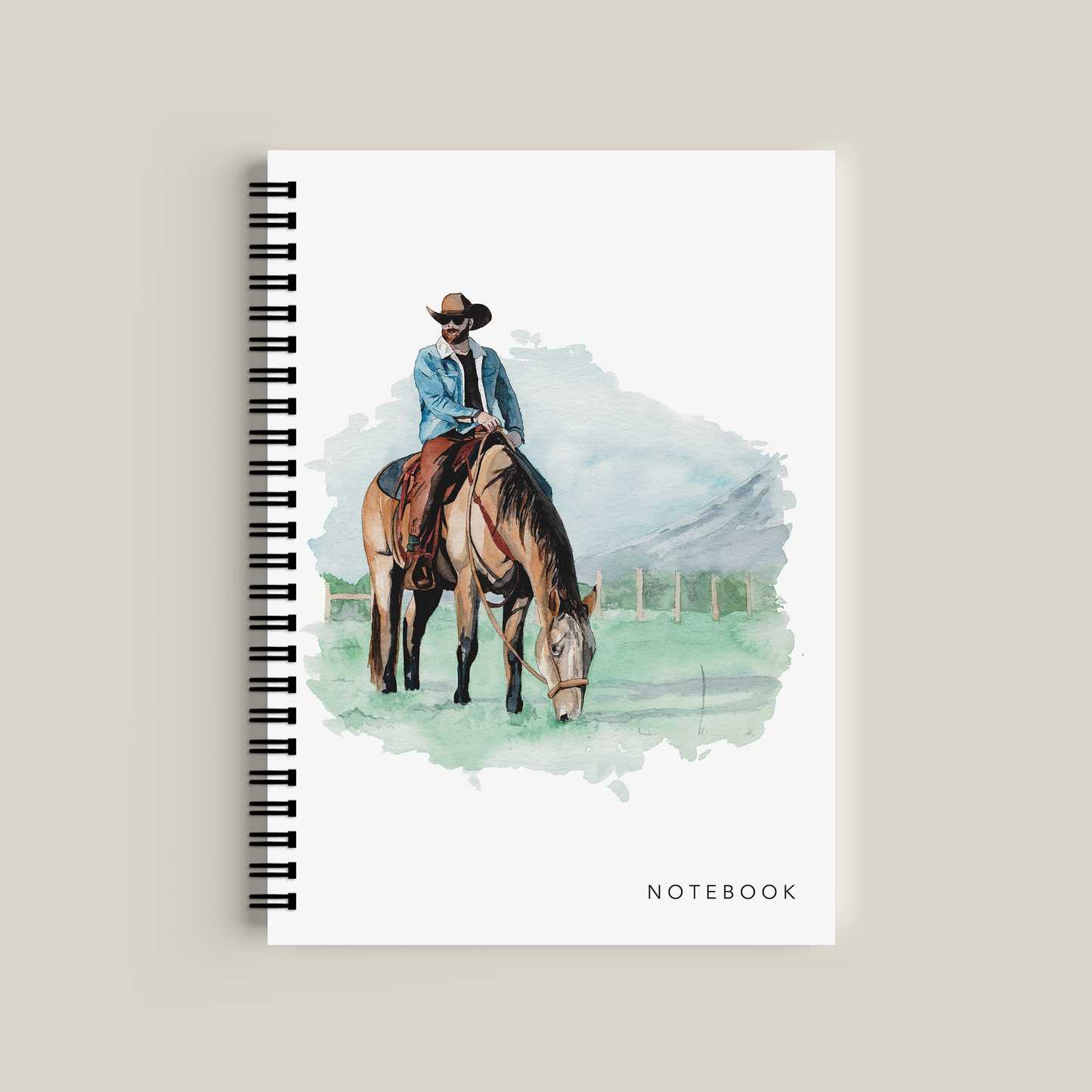 Notebook with a cover illustration of a person on a horse, on a beige background