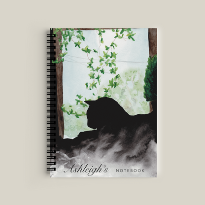 Notebook with a bear silhouette and floral design on the cover, featuring the name 'Ashleigh'.
