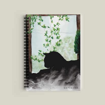 Notebook with a black cat silhouette design on a light background