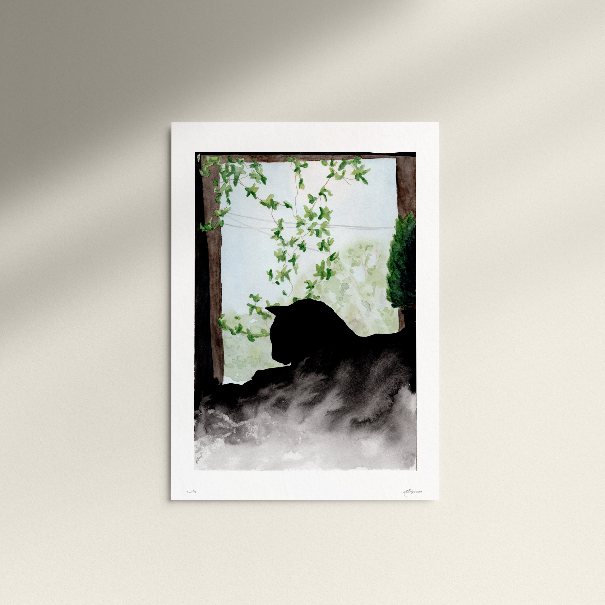 Framed artwork of a silhouette of a cat in a misty forest scene on a white wall.