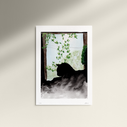 Framed artwork of a silhouette of a cat in a misty forest scene on a white wall.