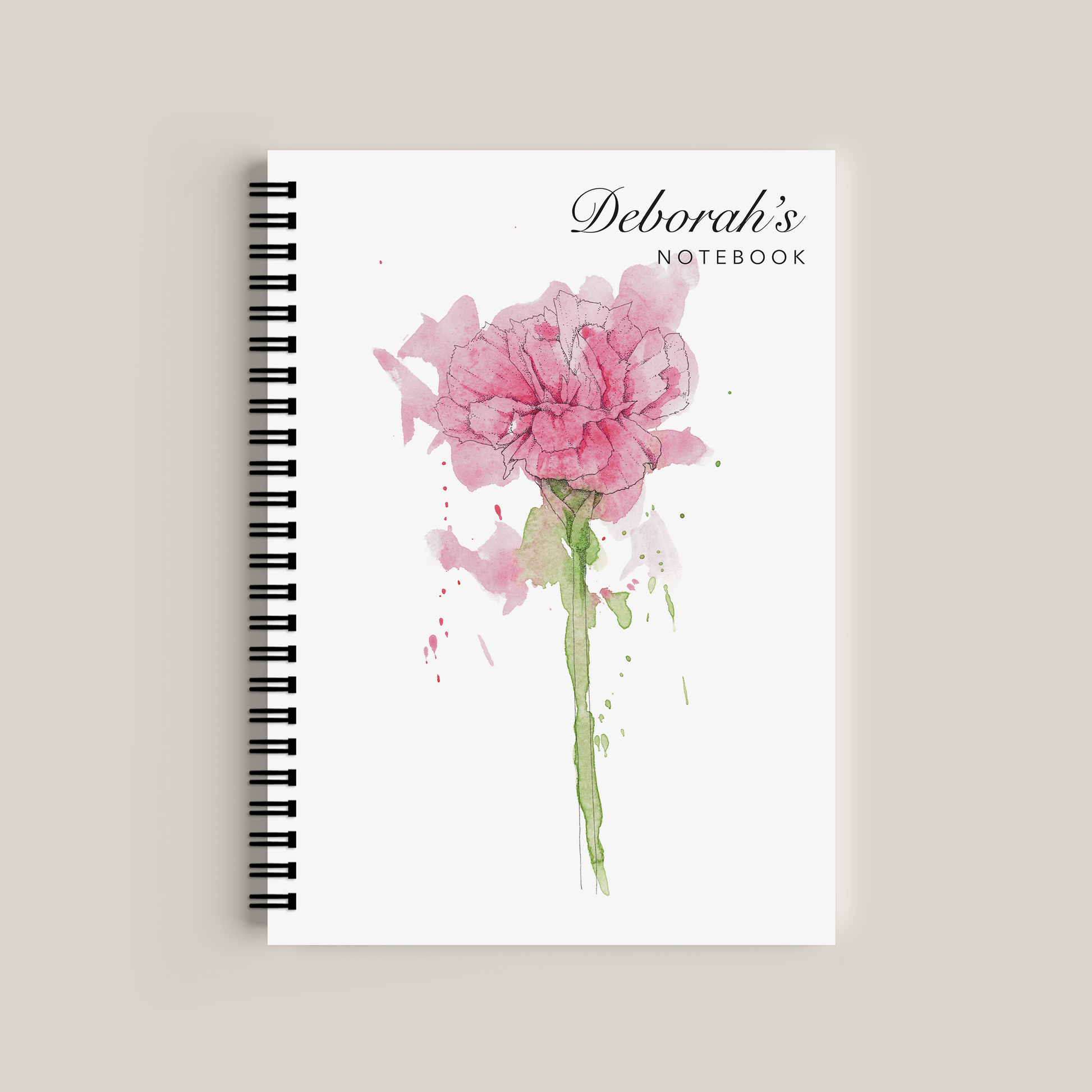 Notebook with pink floral design and 'Deborah's Notebook' text on a beige background