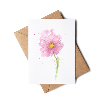 Greeting card with a pink flower illustration on a white background, accompanied by a brown envelope.