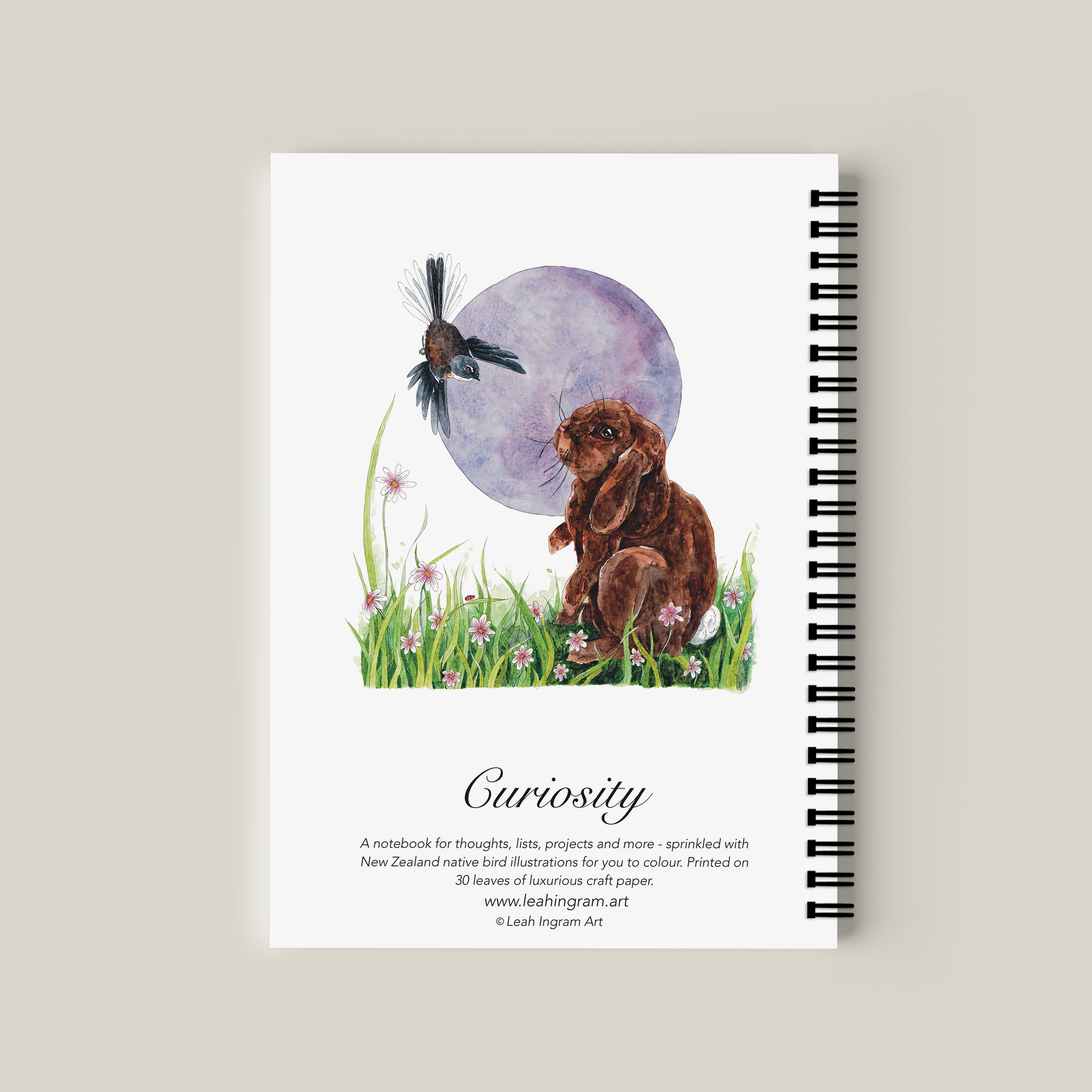 Notebook with a rabbit and butterfly illustration on a beige background