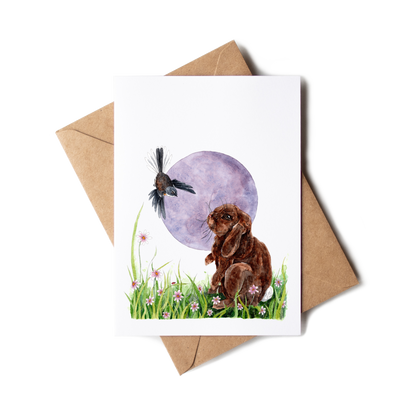 Greeting card with a rabbit and bird illustration on a white background