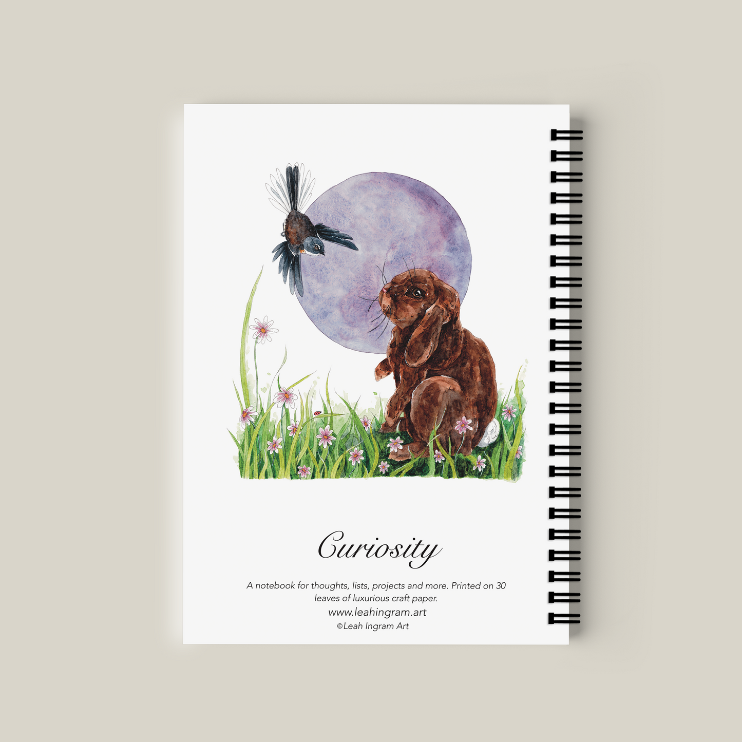 Notebook with illustration of a rabbit, bird, and moon on the cover