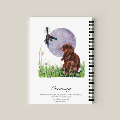 Notebook with illustration of a rabbit, bird, and moon on the cover