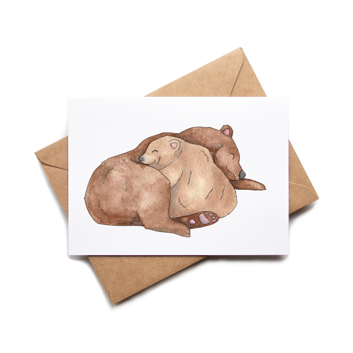 Greeting card with two bears embracing on a white background, accompanied by a brown envelope.