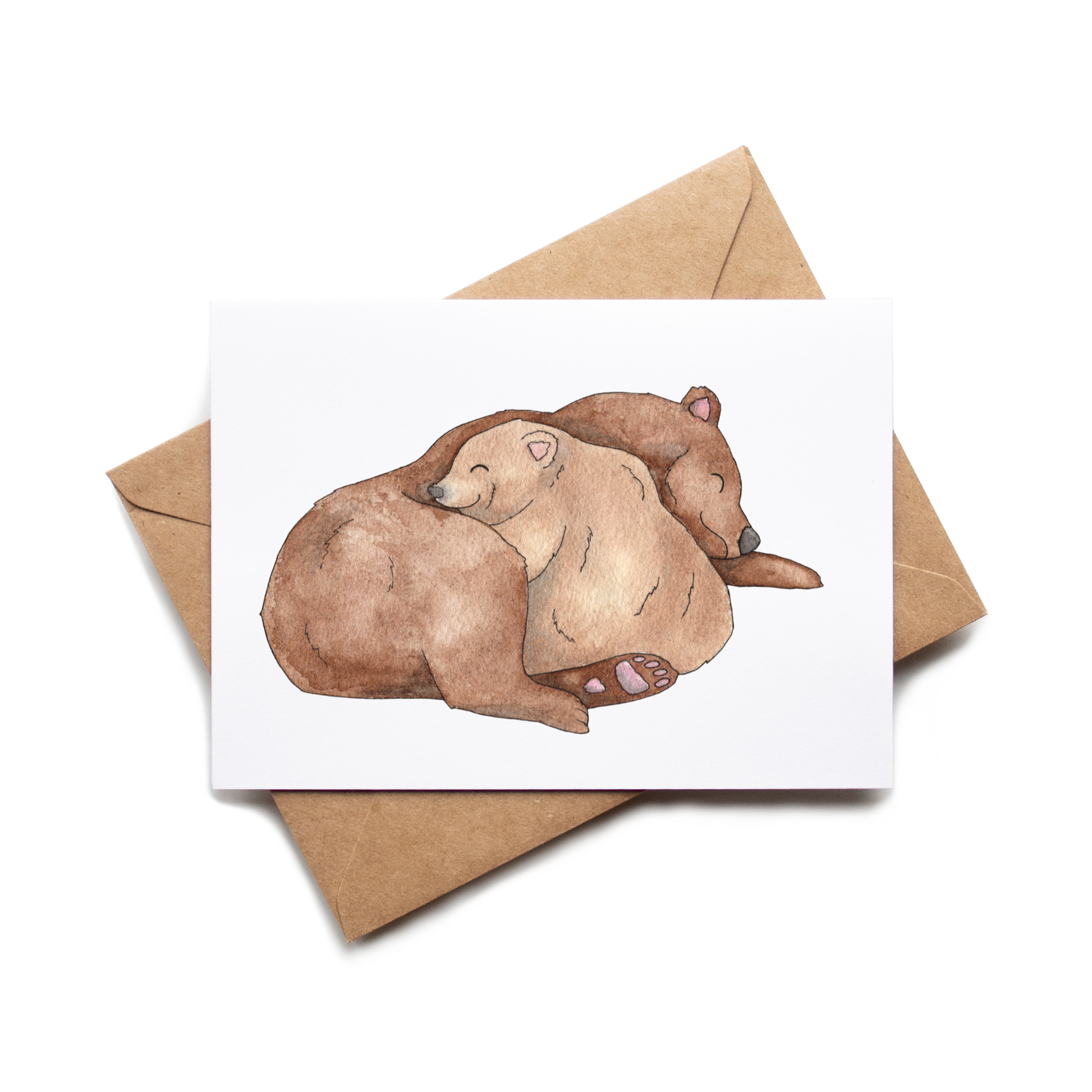 Greeting card with two bears embracing on a white background, accompanied by a brown envelope.
