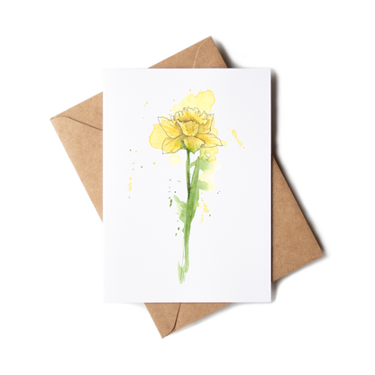 Greeting card with yellow flower design and brown envelope on white background