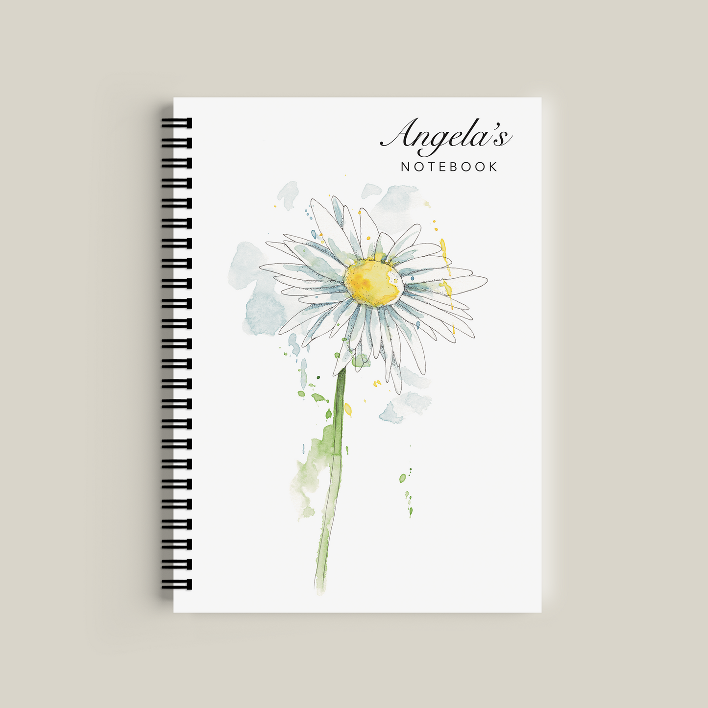 Notebook with a daisy design and 'Angela's Notebook' text on a beige background
