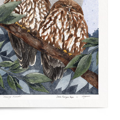 Framed artwork of two owls perched on branches with a textured circular background.