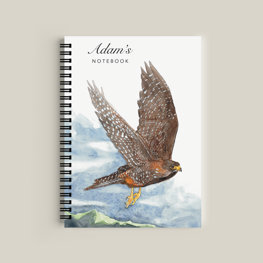 Notebook with a hawk illustration on the cover, titled 'Adam's Notebook'.