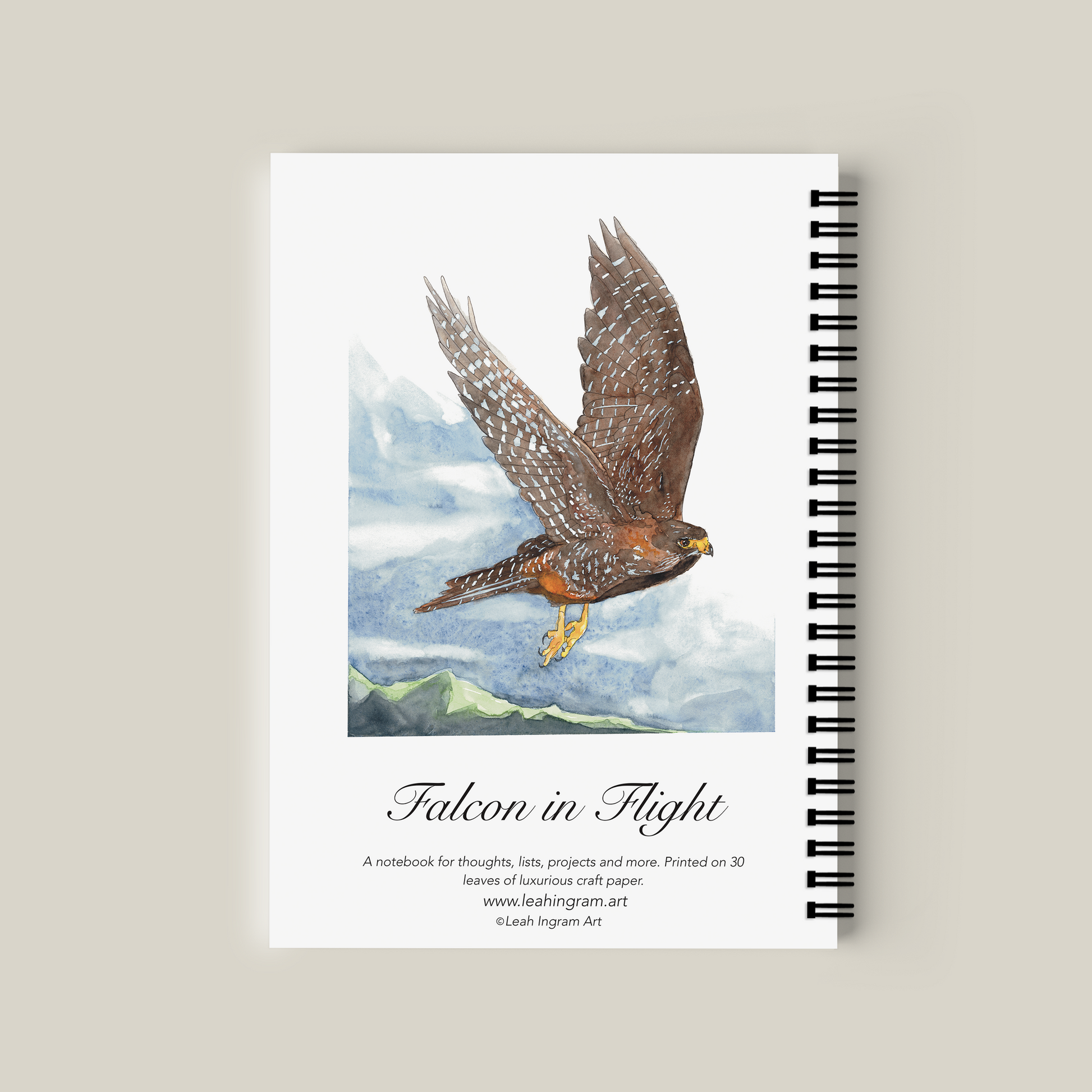 Notebook with a falcon illustration on the cover against a beige background