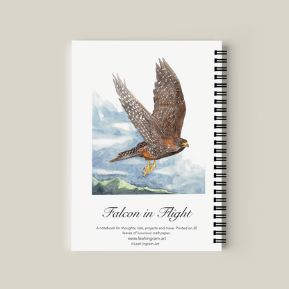 Notebook with a falcon illustration on the cover against a beige background