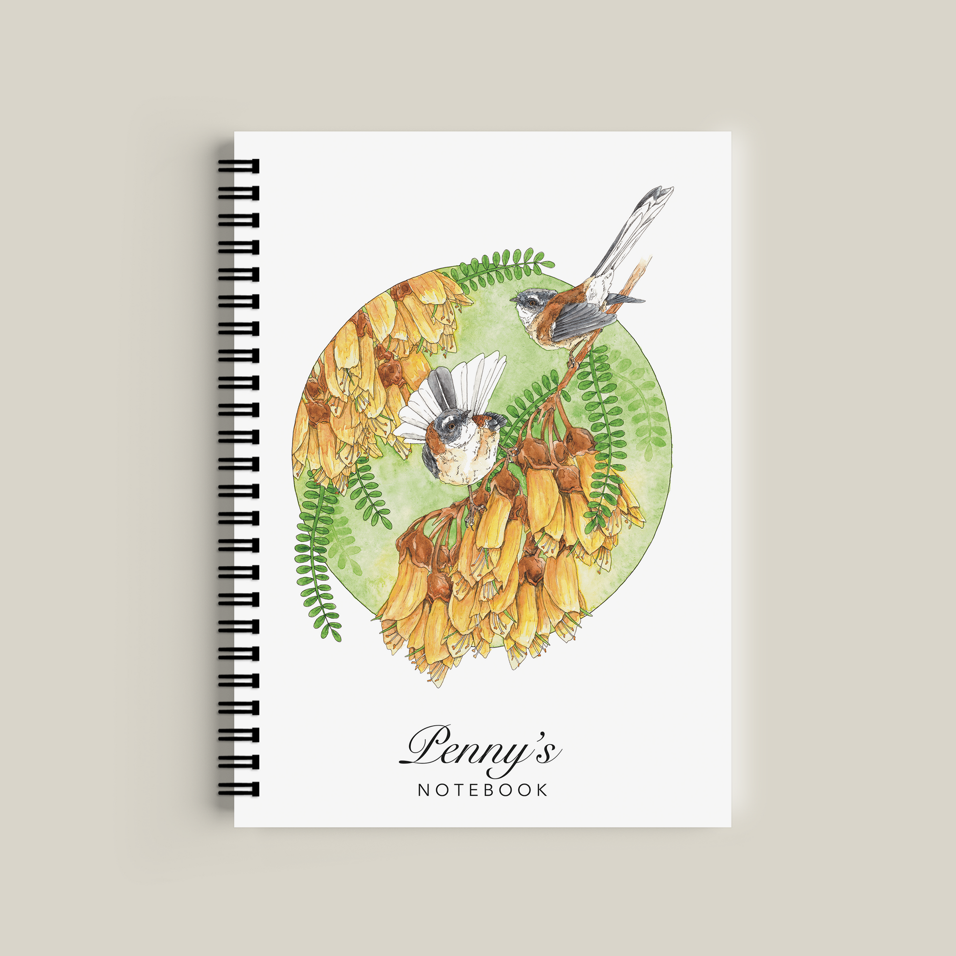 Notebook with nature-themed cover featuring birds and flowers on a beige background