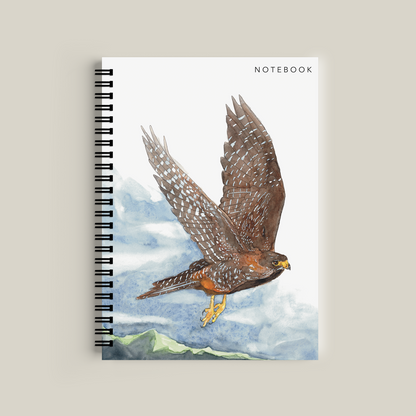 Notebook with a falcon illustration on a mountainous landscape cover