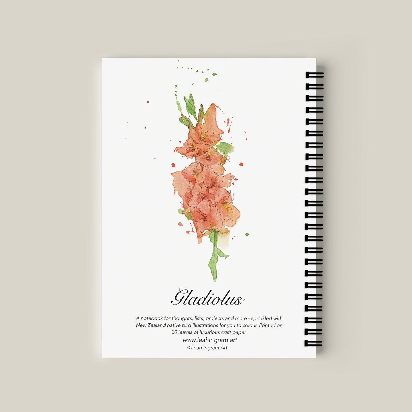 Notebook with floral design on the cover against a beige background