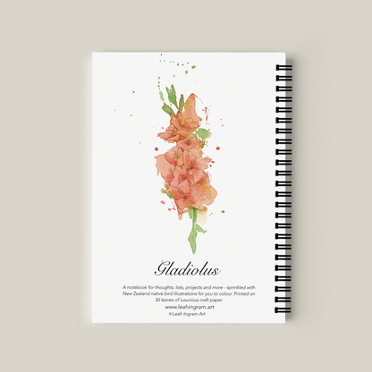 Notebook with floral design on the cover against a beige background