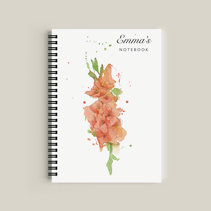 Notebook with floral design and 'Emma's Notebook' text on a beige background