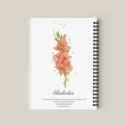 Notebook with floral design on the cover against a beige background