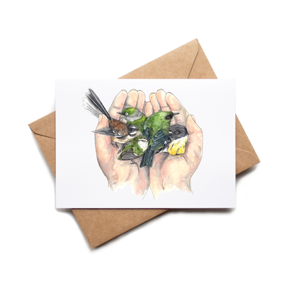 Card with illustration of hands holding birds on a white background with a brown envelope.