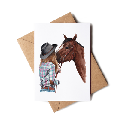 Greeting card with illustration of a person and horse, accompanied by a brown envelope on a white background.