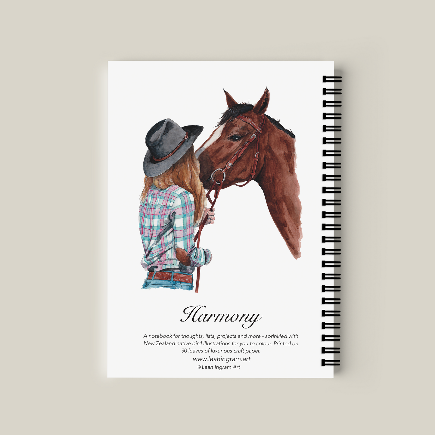 Notebook with illustration of a woman and horse on the cover, titled 'Harmony'.