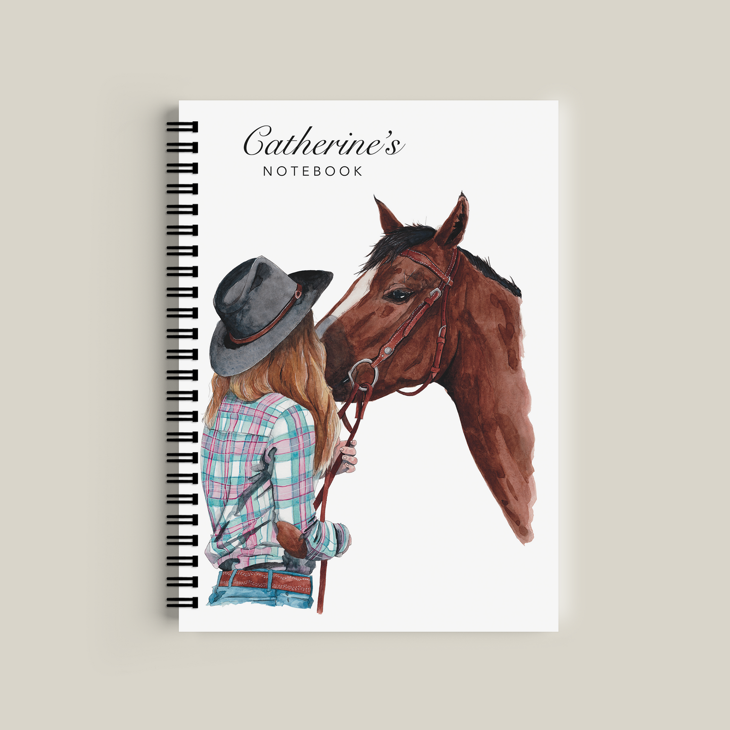 Notebook with a horse and person design on the cover, titled 'Catherine's Notebook'.