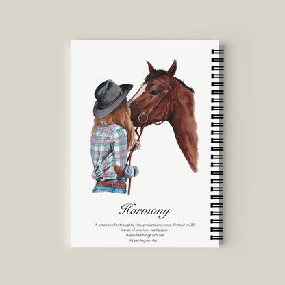 Notebook with illustration of a person and horse on the cover, titled 'Harmony'.