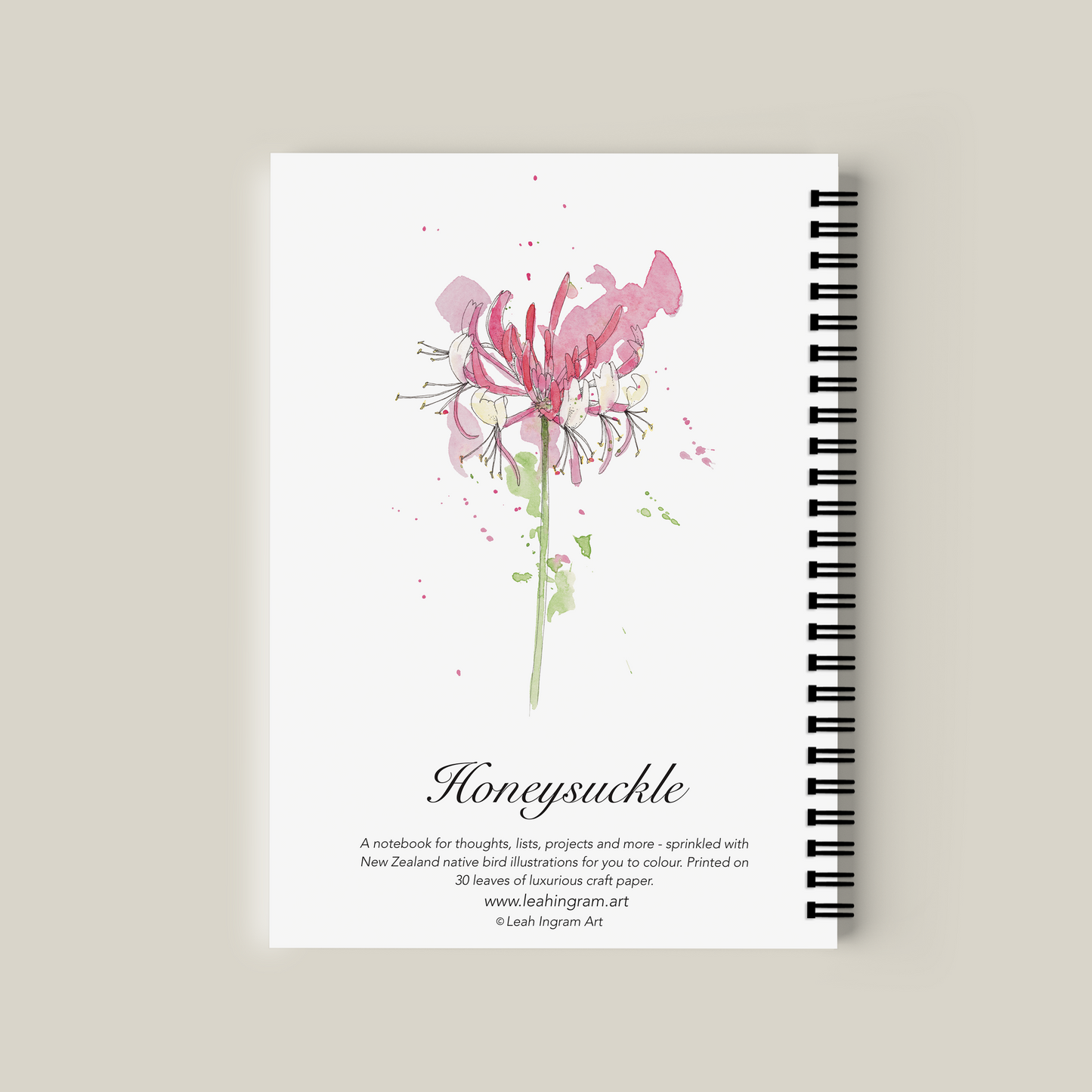 Notebook with a pink flower illustration on a beige background