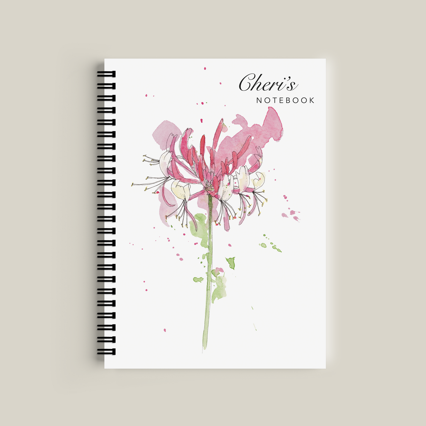 Notebook with floral design and 'Cheri's' branding on a beige background